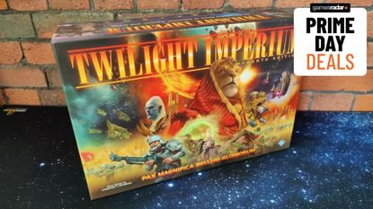 A Twilight Imperium board game box against a brick wall, sat on a starry mat, with a 'Prime Day deals' badge in the top right corner of the frame