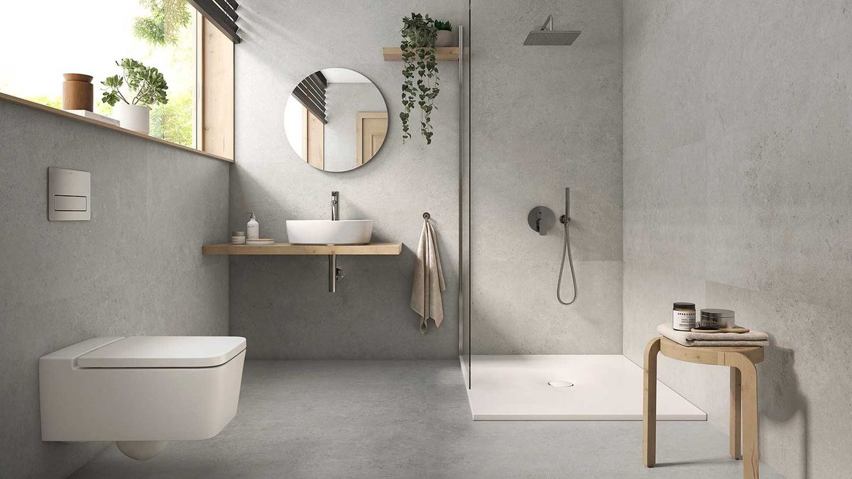 modern grey bathroom with walk-in shower and wall hung toilet and countertop basin