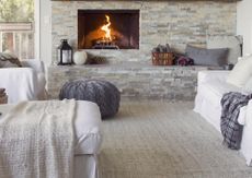 A living room with a small pumpkin decorative on the mantel