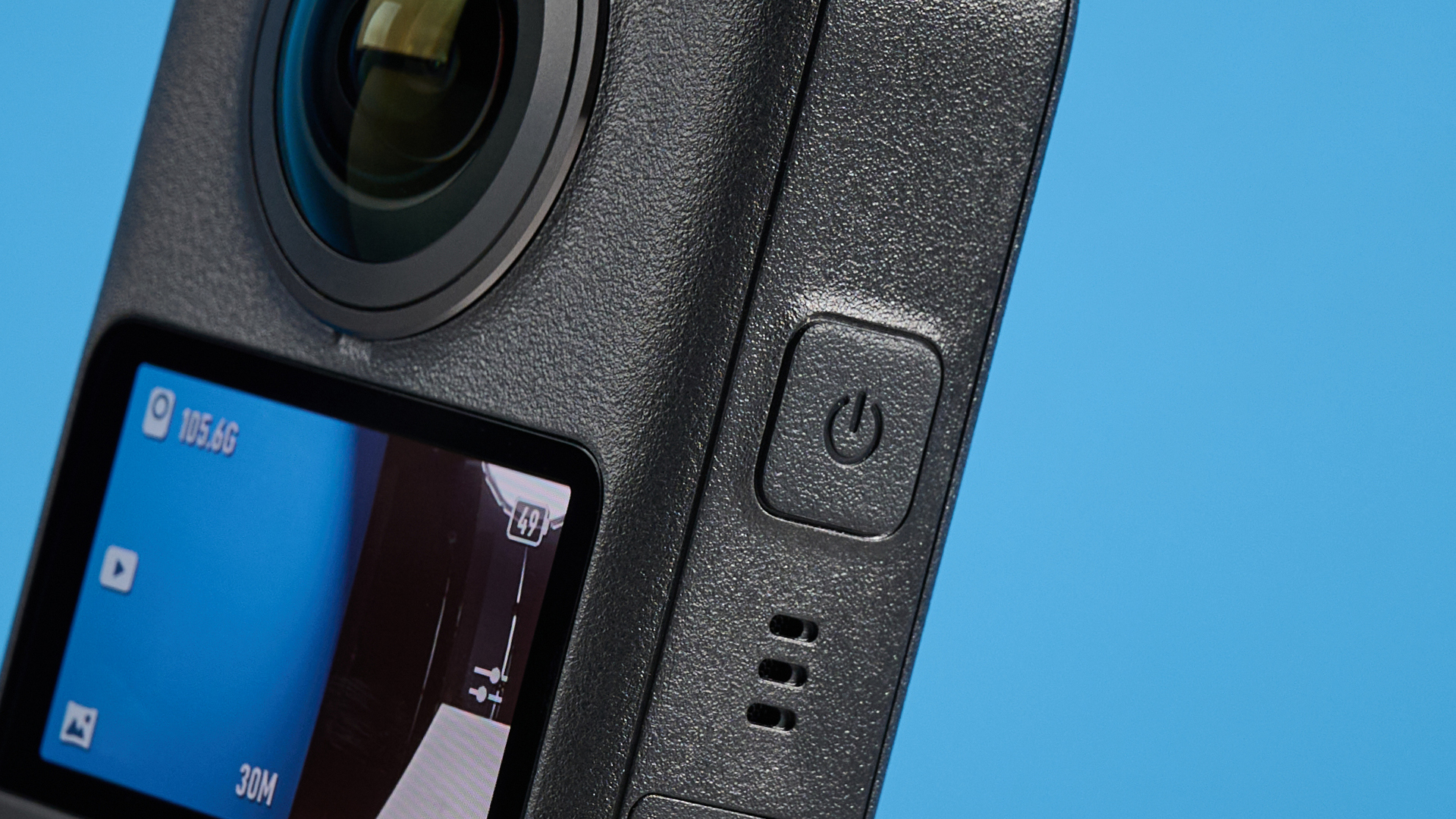 The DJI Osmo 360 power button against a blue background