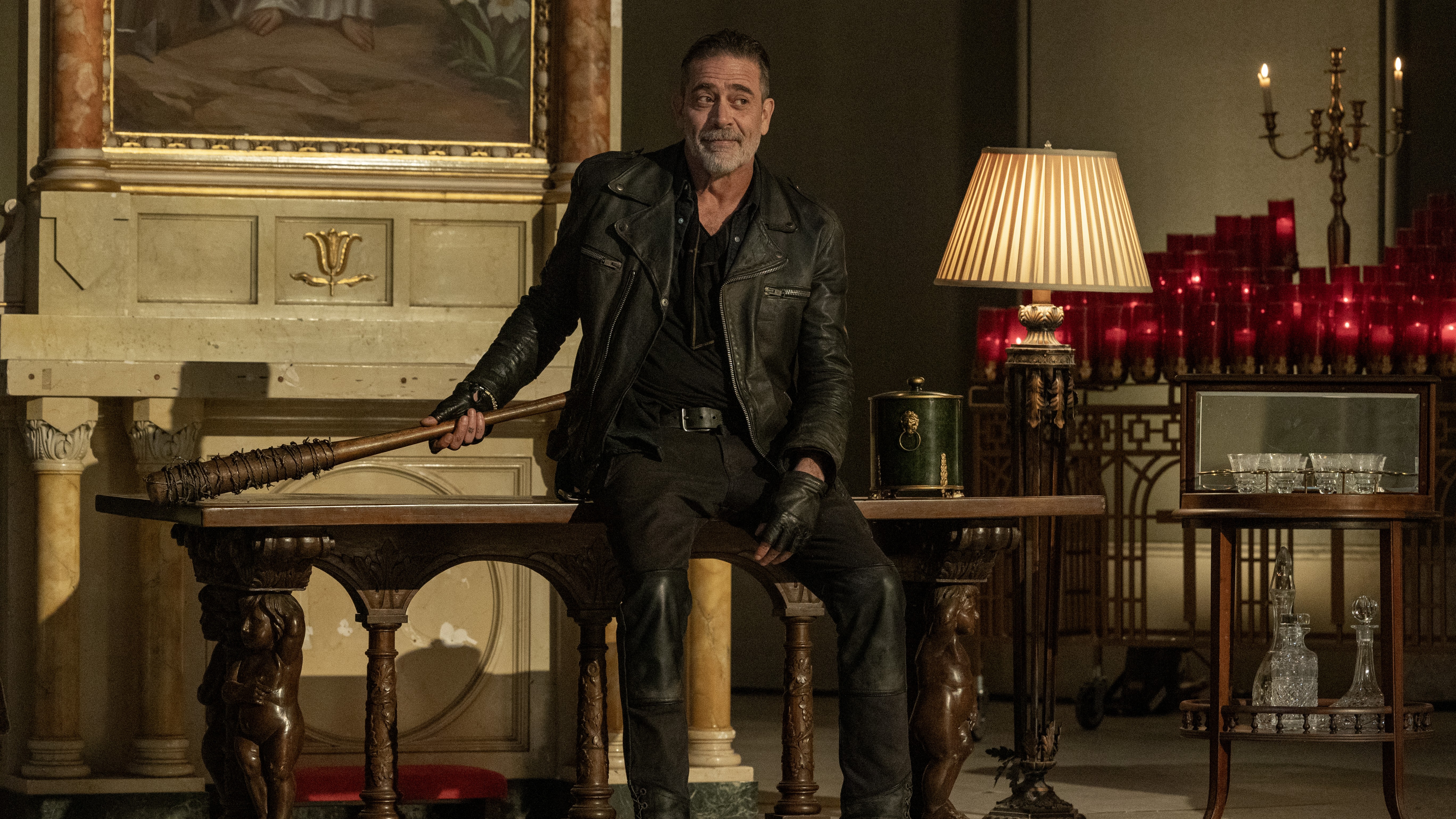 Negan (Jeffrey Dean Morgan) dressed in black leather with his bat, Lucille, in The Walking Dead: Dead City season 2