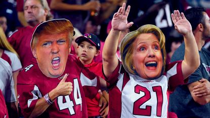 Arizona Cardinals fans wear masks of presidential candidates Donald Trump and Hillary Clinton at an NFL game