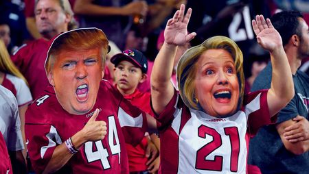 Arizona Cardinals fans wear masks of presidential candidates Donald Trump and Hillary Clinton at an NFL game