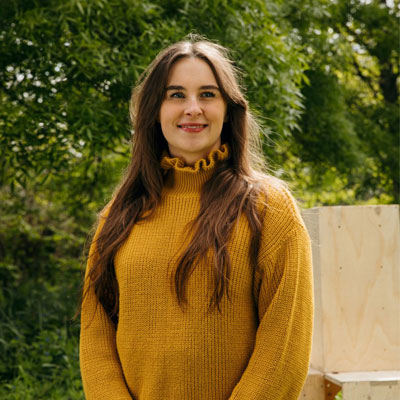 headshot of architect Ella Thorns, a young woman with long dark hair