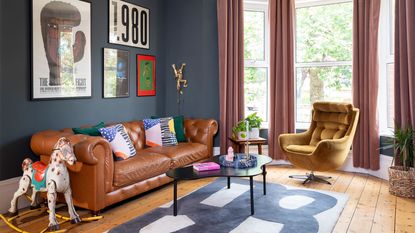 blue living room with leather sofa and artwork