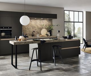 modern kitchen with dark units, island, prep area and modern black barstools