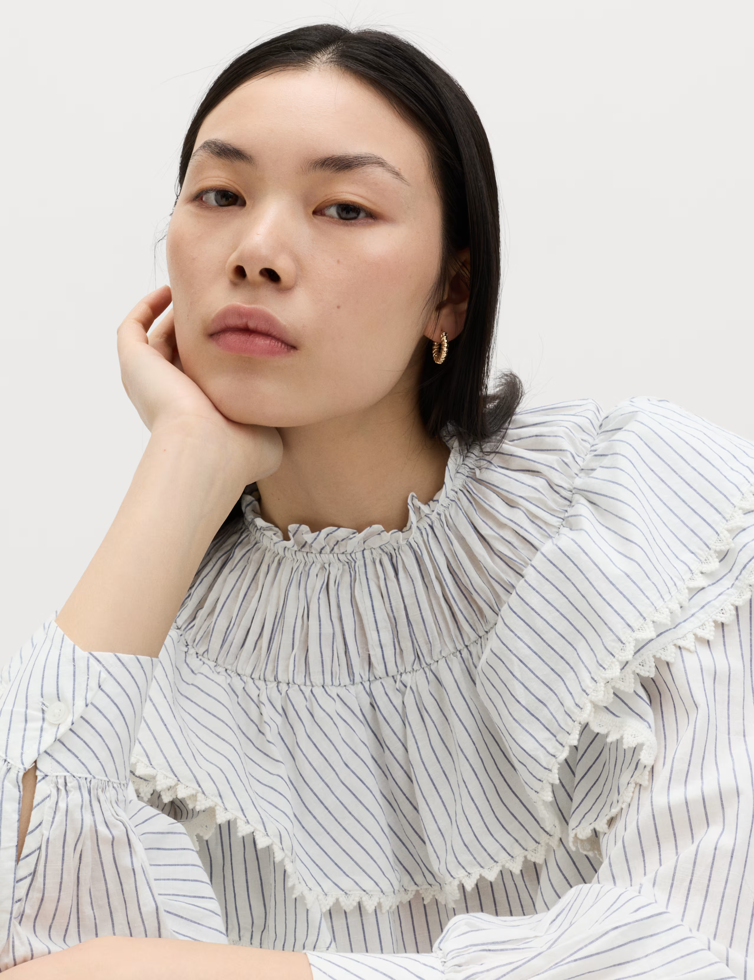 A model wearing a Marks and Spencer ruffled blouse.