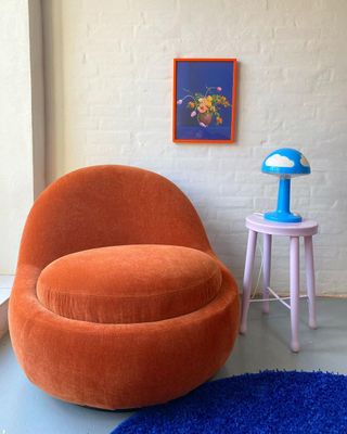 Orange chair and pastel footstool