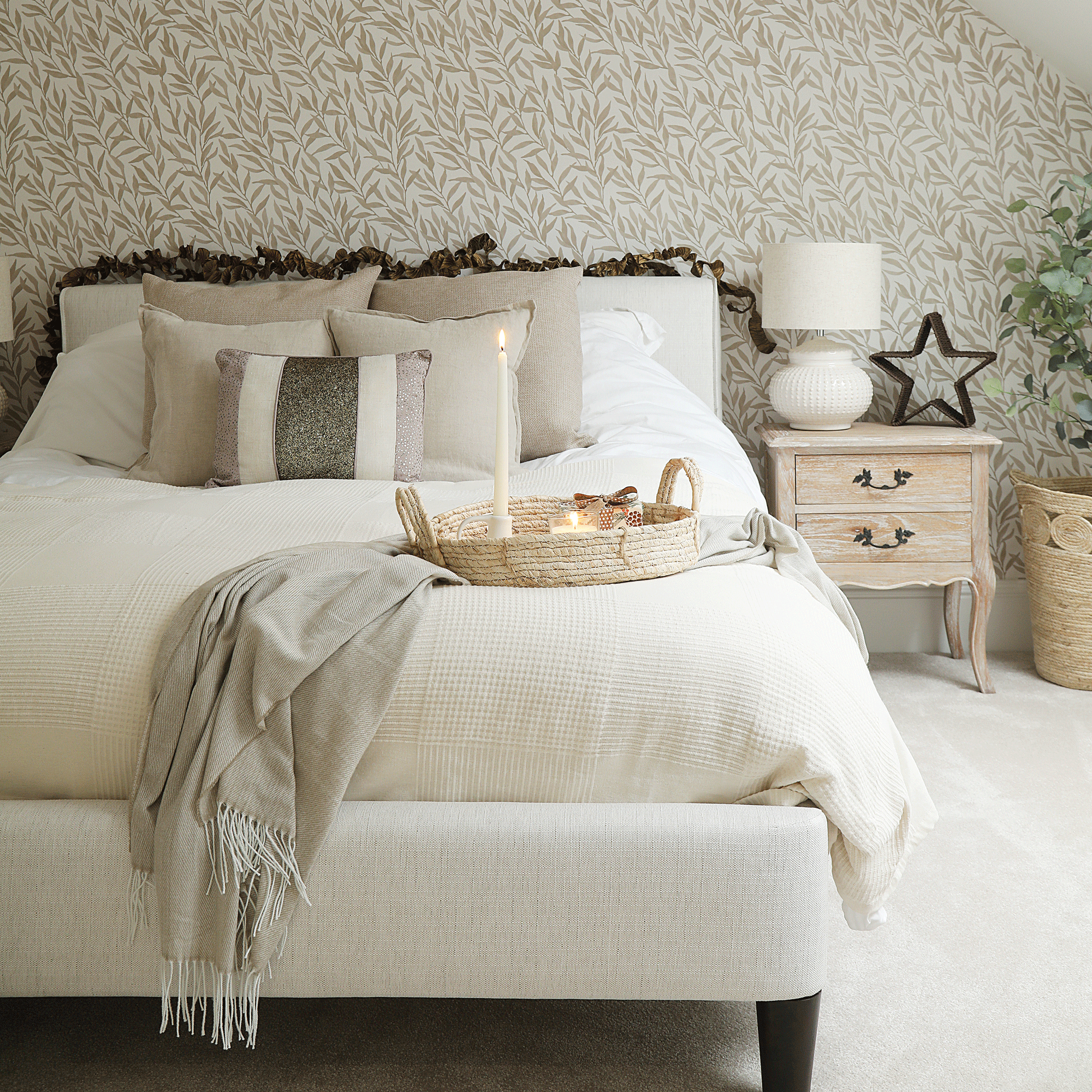a neutral bedroom with nature-inspired wallpaper decorated for Christmas