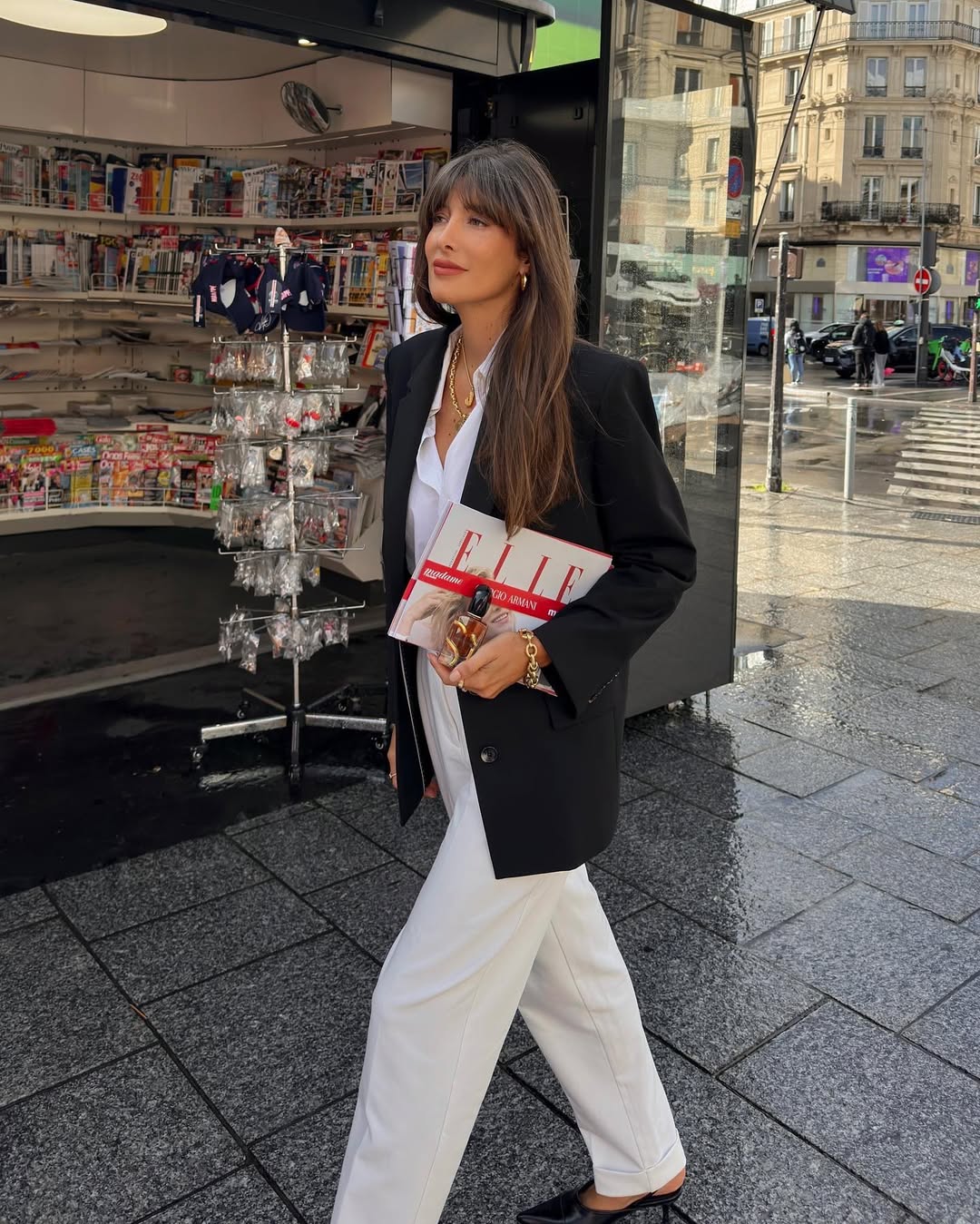 Julie in a black blazer and white denim