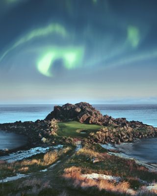 A general view of Lofoten Links in Norway with the Norther Lights swirling above