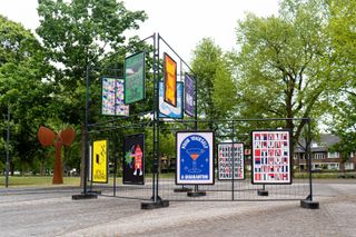 Posters displayed on a metal structure outdoors in a park