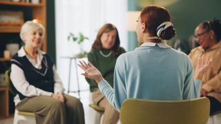 Woman sitting in a circle in therapy, representing CBT group for menopause