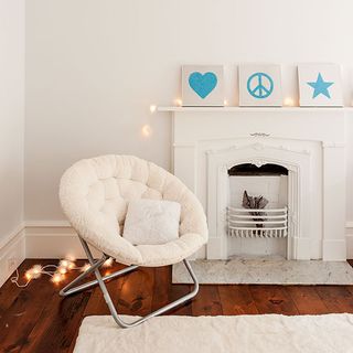 children room with wooden floorboard white folding chair and white rug