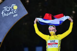 Tadej Pogacar wears the yellow jersey as the winner of the Tour de France