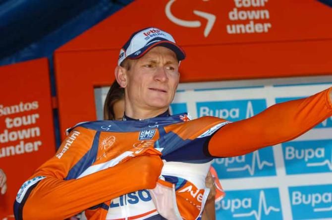 Andre Greipel (Lotto Belisol) pulls on the ochre jersey.