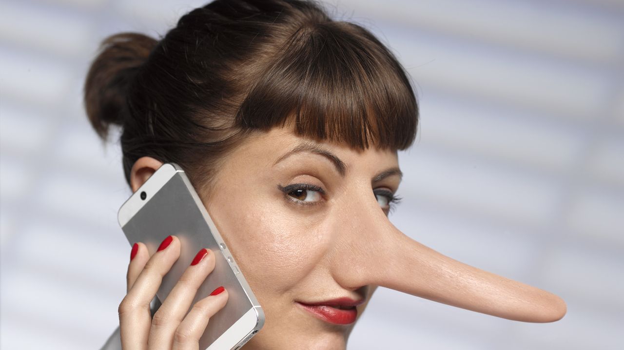 Woman with long Pinocchio nose on mobile phone.