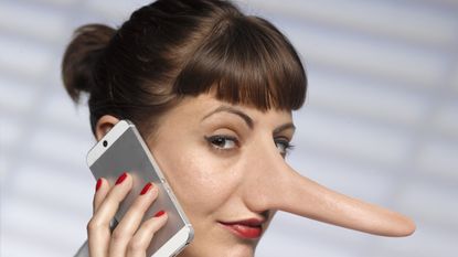 Woman with long Pinocchio nose on mobile phone.