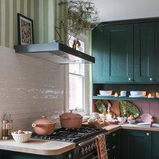 Two Always Pans on a hob in a pink and green kitchen