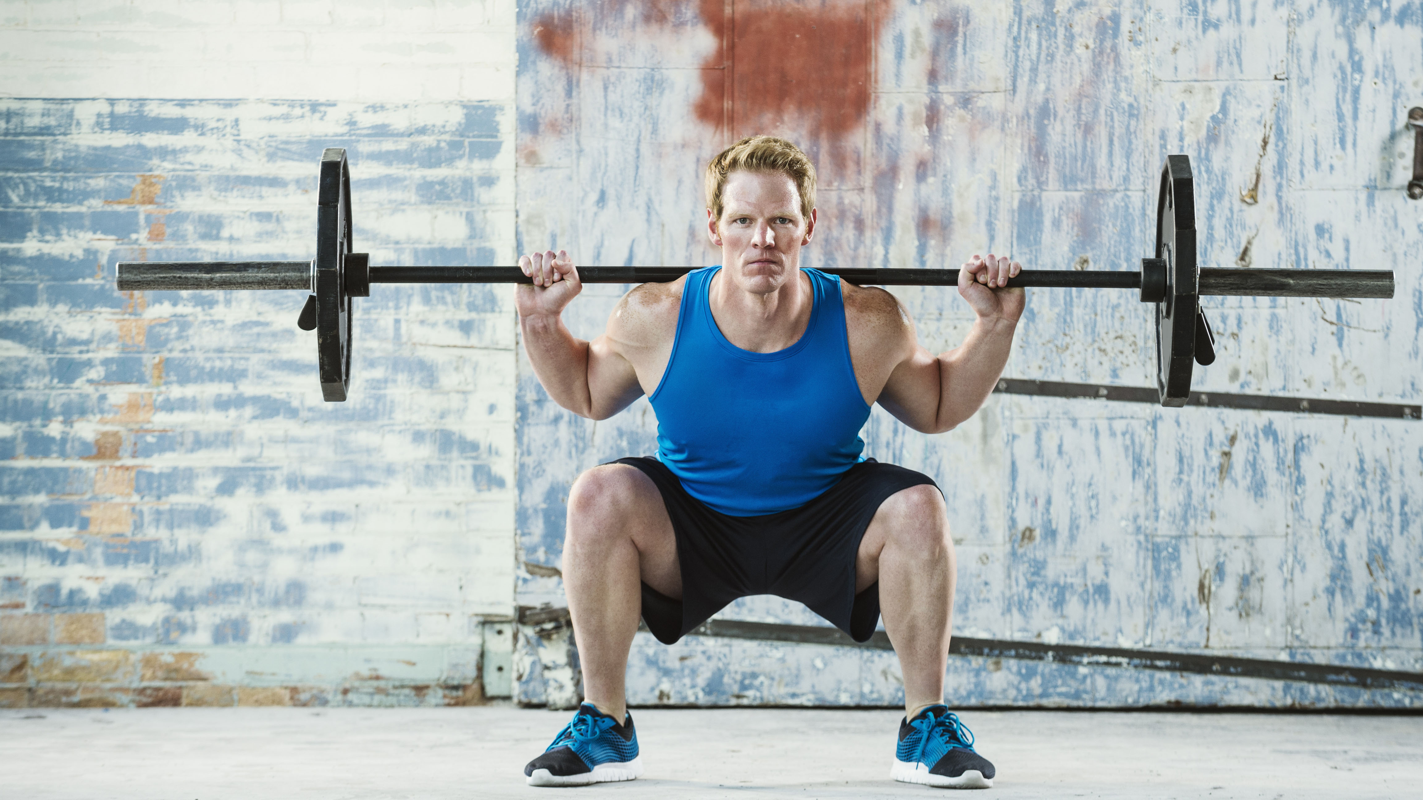 Man performing back-weighted squat