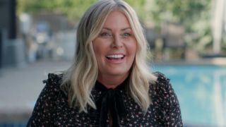 Nicole Eggert laughing and smiling as she sits poolside during an interview for After Baywatch: Moment in the Sun.