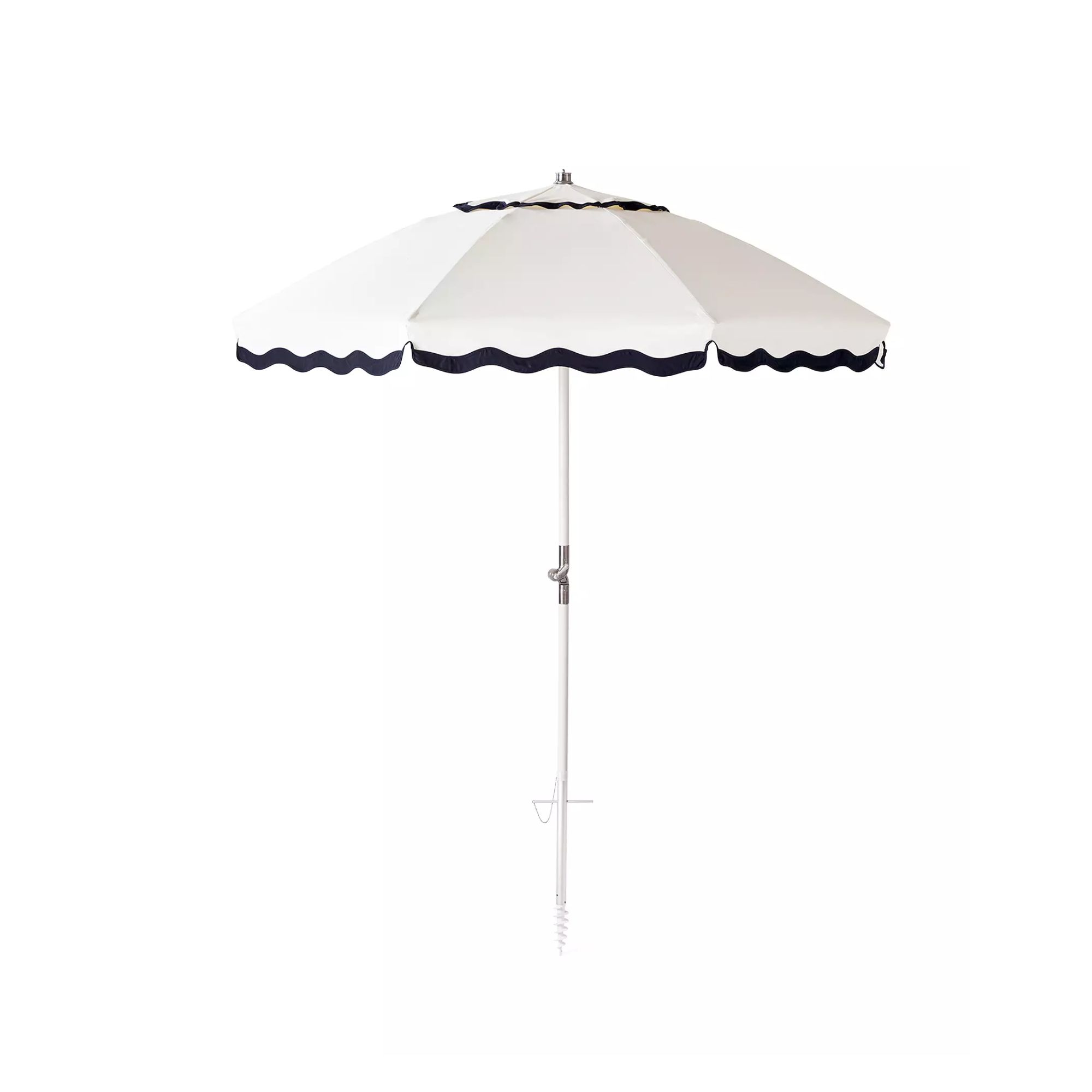 A white outdoor umbrella with wavy navy blue edges and a white pole