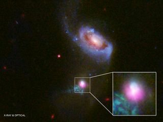 Researchers observed the supermassive black hole at the center of the galaxy SDSS J1354+1327 with the Chandra X-ray Telescope (pink) and Hubble Space Telescope, noticing evidence of two "burps" of high-energy particles emanating from the black hole. One (below the black hole) has spread further, suggesting it burst out 100,000 years before the other (above the black hole).