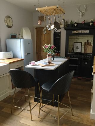 small kitchen island in farmhouse style kitchen, hanging pot rack