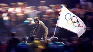 Tom Cruise leaves the Paris Summer Olympics closing ceremony with the Olympic flag