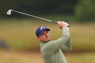 Matt Wallace hits an iron shot and watches its flight