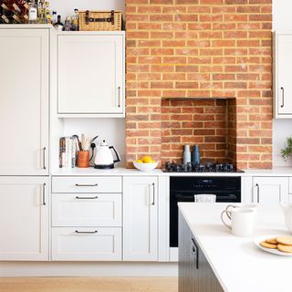 neutral kitchen with brick wall