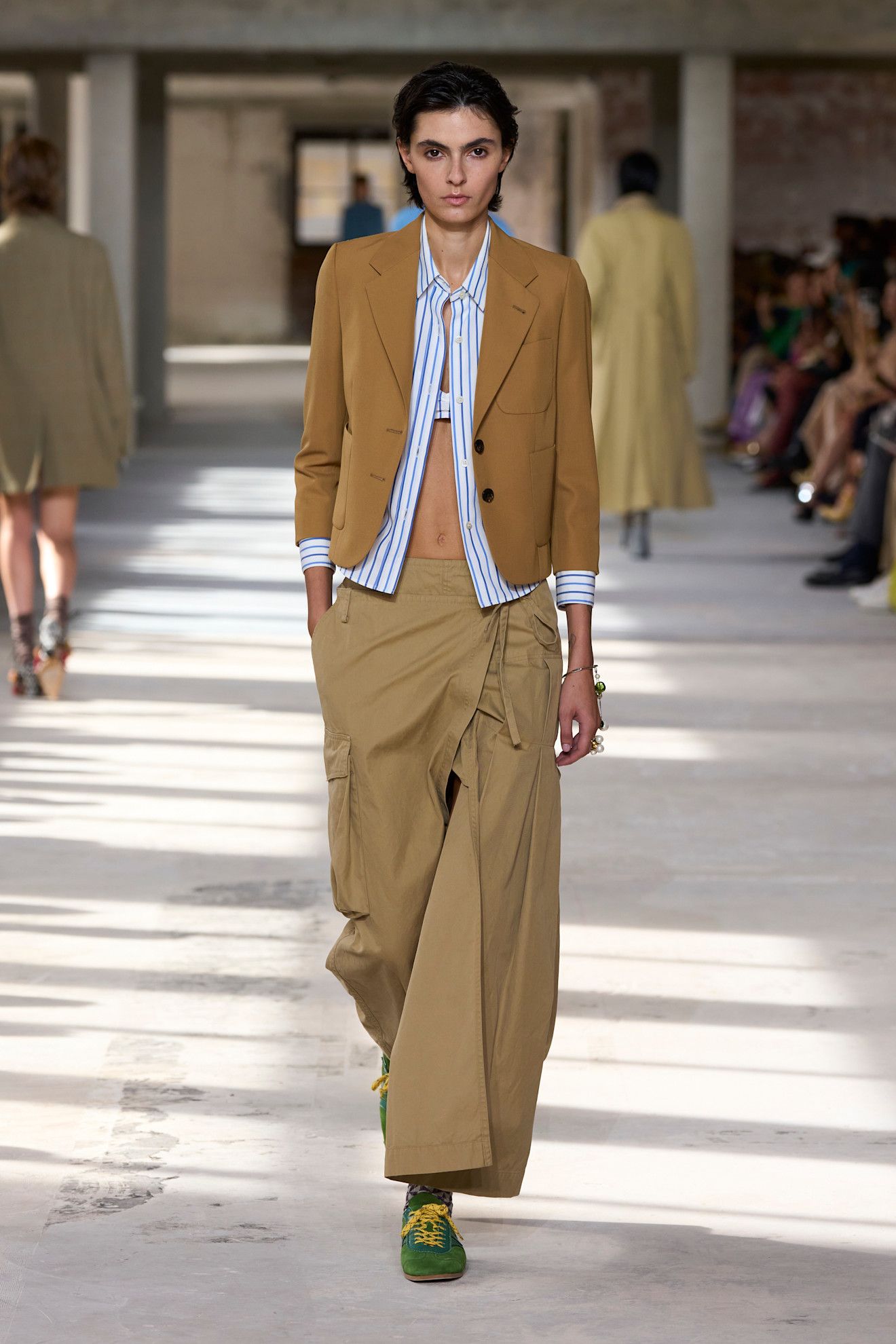 Model wears Dries Van Noten trainers on the runway.