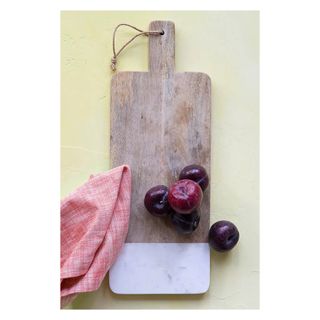 Wood and marble chopping board with fruit and kitchen towel