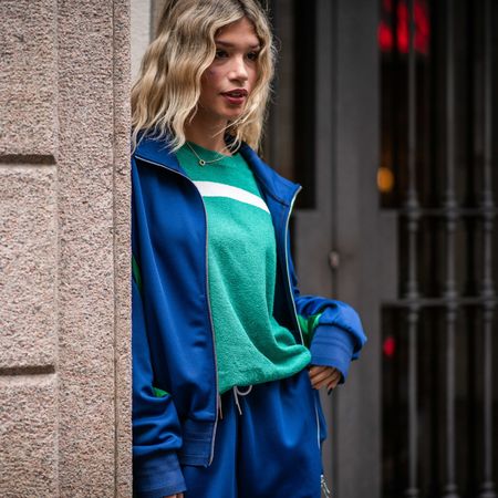 woman wearing athleisure: blue sweats and a hoodie