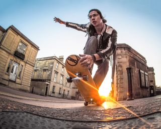 Use a fisheye lens low to the ground to create action-filled creative photos 