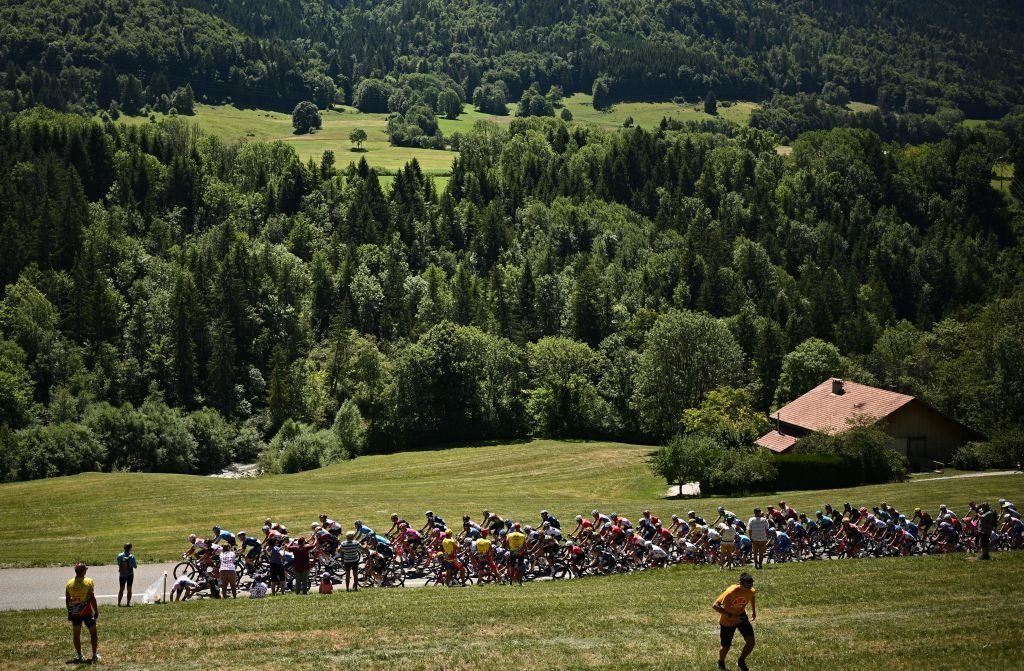 The pack of riders cycles during the 10th stage of the 109th edition of the Tour de France cycling race 1481 km between Morzine and Megeve in the French Alps on July 12 2022 Photo by Marco BERTORELLO AFP Photo by MARCO BERTORELLOAFP via Getty Images