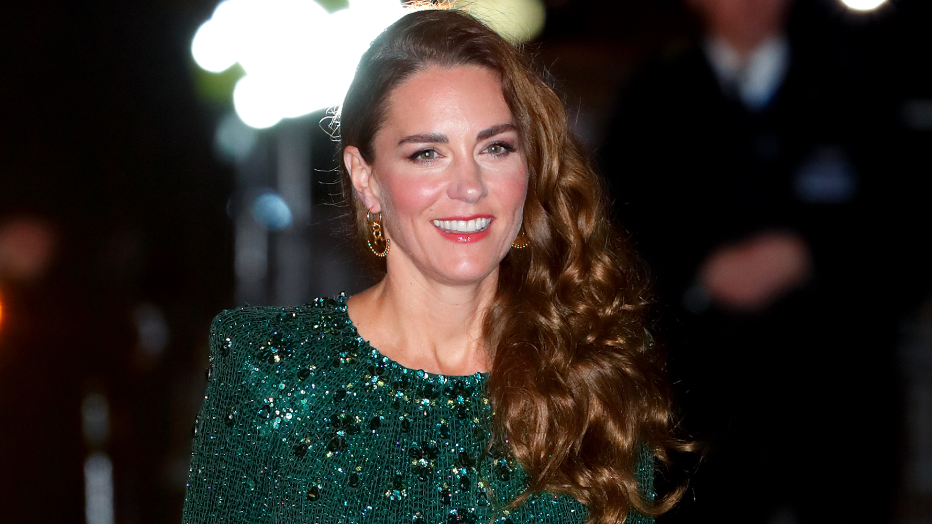 Kate Middleton has long curly brown hair and wears a green sequin gown for the Royal Variety Performance at London's Royal Albert Hall on November 18, 2021
