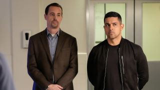 Sean Murray and Wilmer Valderrama standing in NCIS autopsy room