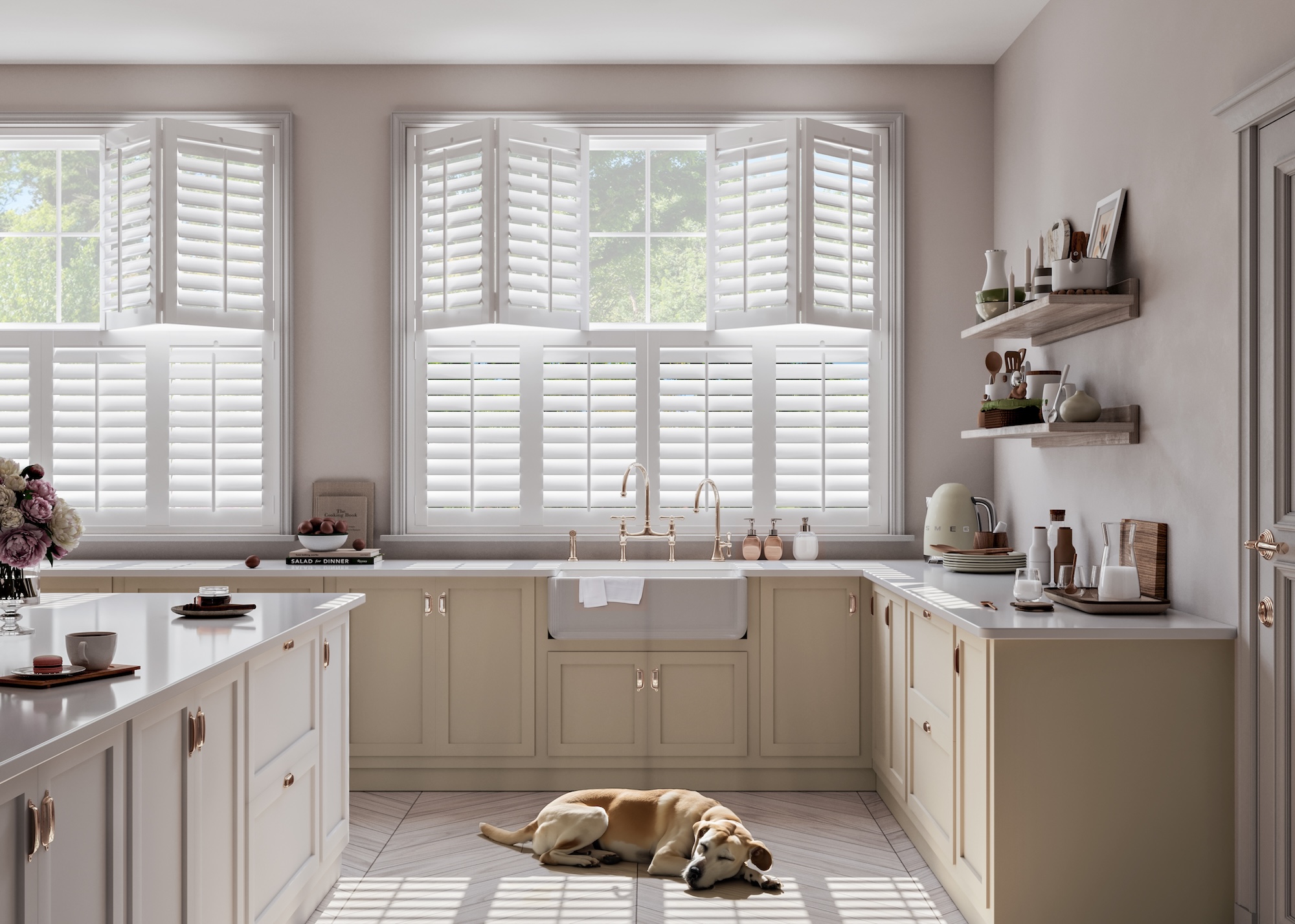 A cashmere colored kitchen with a Belfast sink and an island in the middle. In the kitchen is a god sleeping beneath the kitchen cabinets. The kitchen also has open shelving with kitchen accessories placed on top