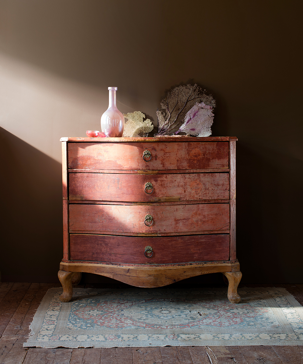 A dresser against a brown wall