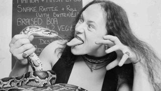 Venom singer Cronos pretending to eat a live snake in 1983