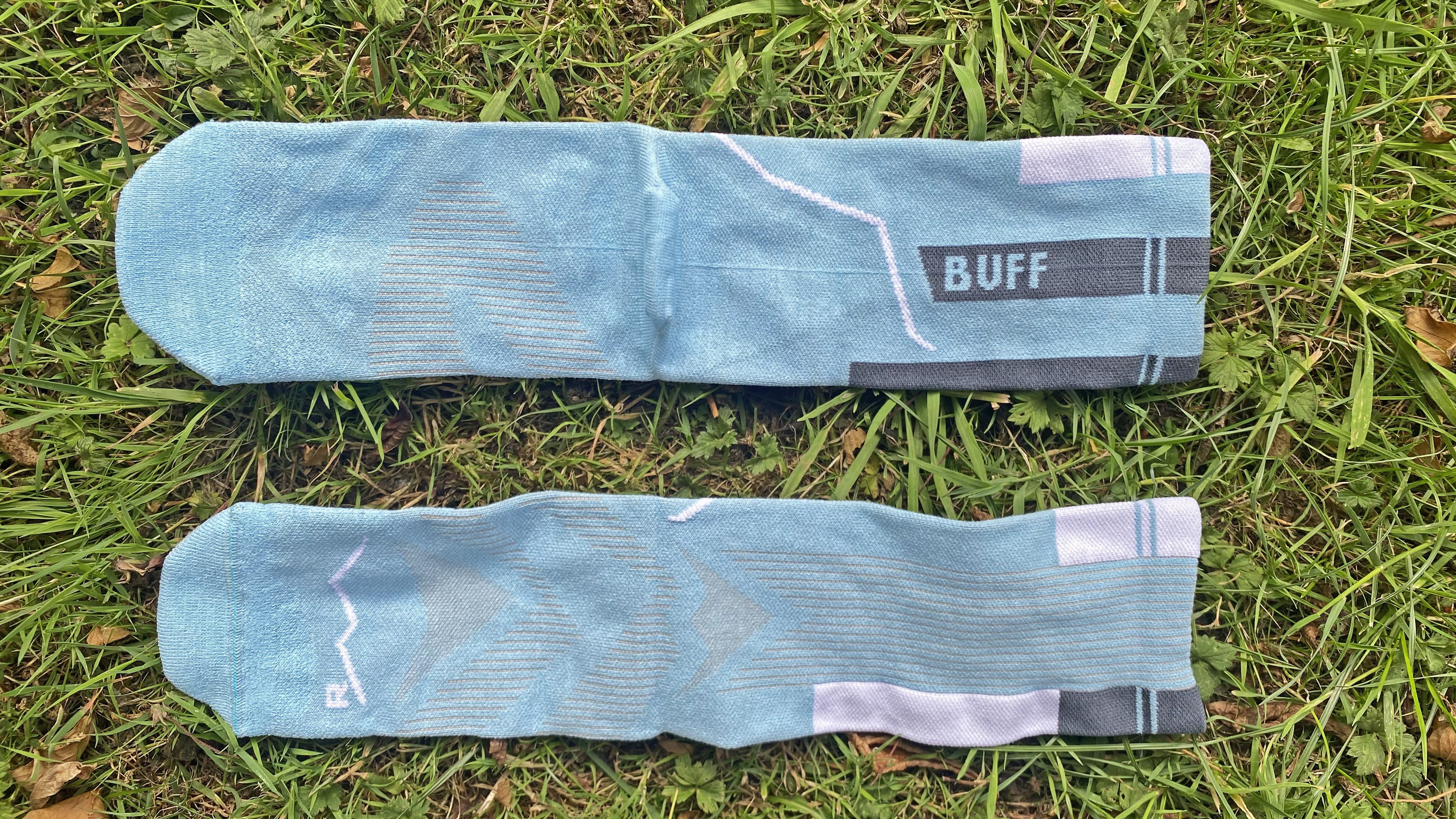 Buff CoolNet Crew running socks, shown on grass
