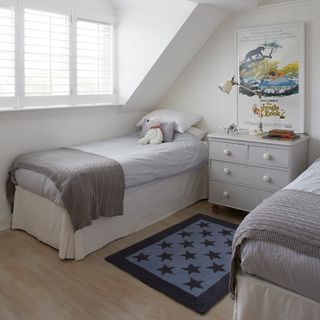 childrens room with wooden flooring and star print rug