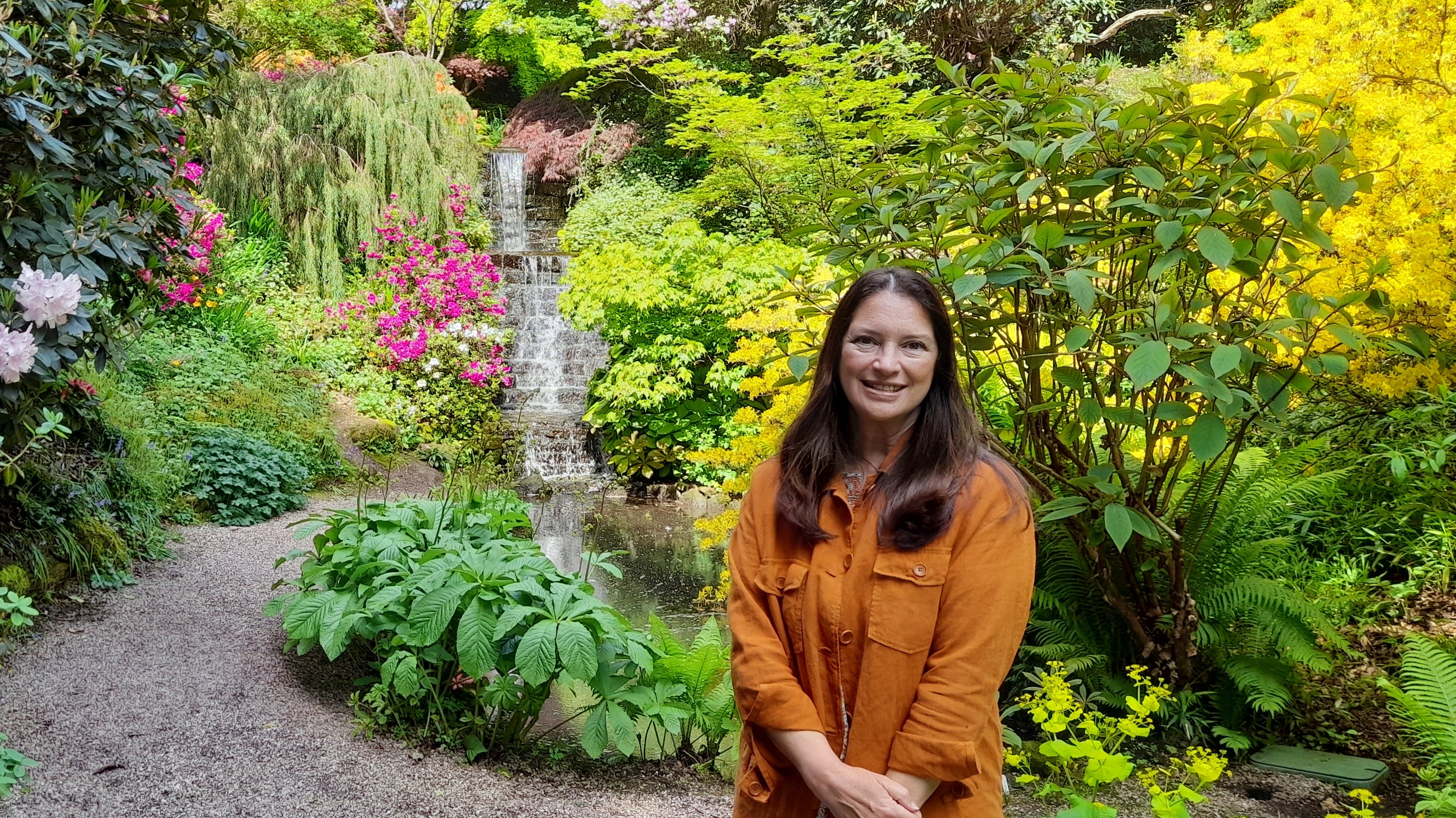 Rachel de Thame standing in front of a waterfall at The RHS Chelsea Flower Show 2025