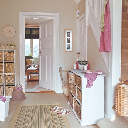 A hallway with wicker storage baskets