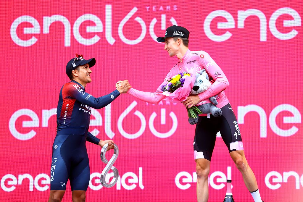 VERONA ITALY MAY 29 LR Richard Carapaz of Ecuador and Team INEOS Grenadiers on second place and race winner Jai Hindley of Australia and Team Bora Hansgrohe Pink Leader Jersey pose on the podium ceremony after the during the 105th Giro dItalia 2022 Stage 21 a 174km individual time trial stage from Verona to Verona ITT Giro WorldTour on May 29 2022 in Verona Italy Photo by Michael SteeleGetty Images