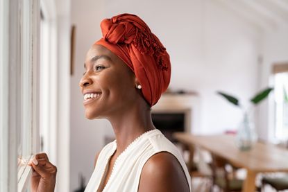 a woman in a head turban showing bowel cancer symptoms