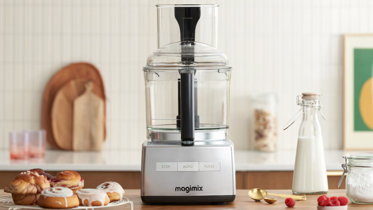 Magimix 4200XL Food Processor on a wooden kitchen counter, surrounded by patisserie, fresh milk and fruit