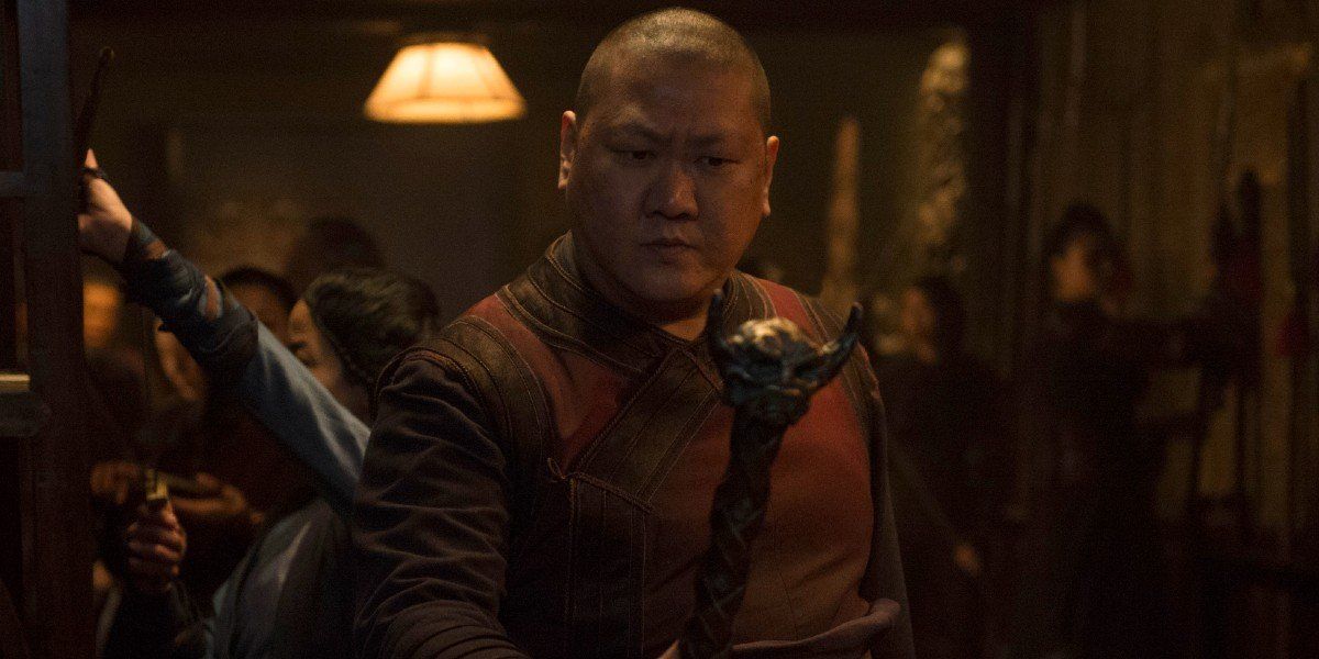 Wong (Benedict Wong) stares at a staff in Doctor Strange (2016)