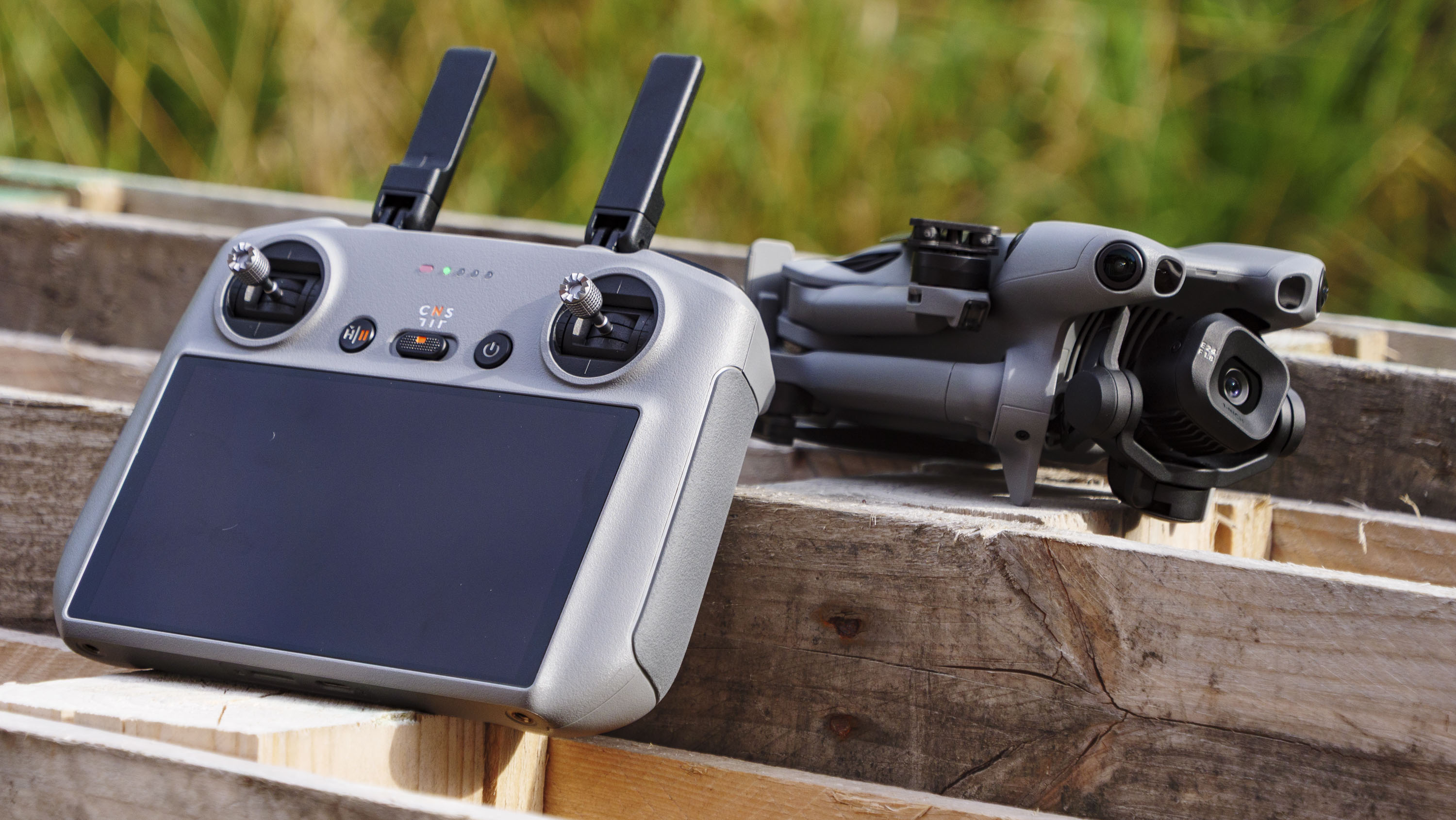 DJI Mini 5 Pro drone rested on a wooden crate alongside the RC 2 controller
